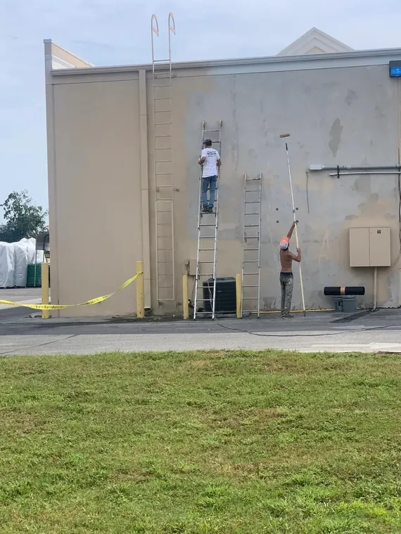 The Fresh Coat crew prepping and painting a commercial building exterior