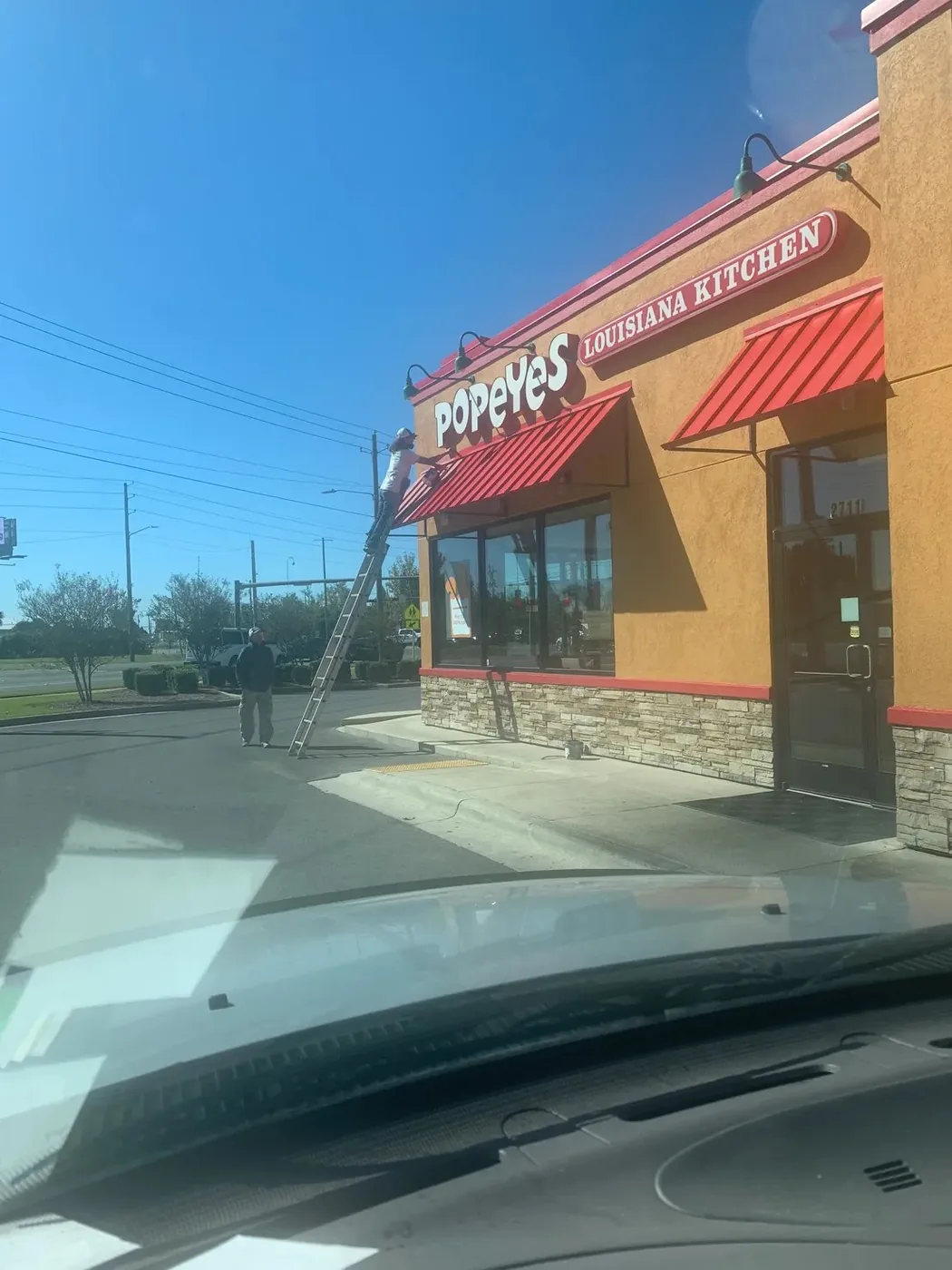 Crew repainting a commercial restaurant exterior