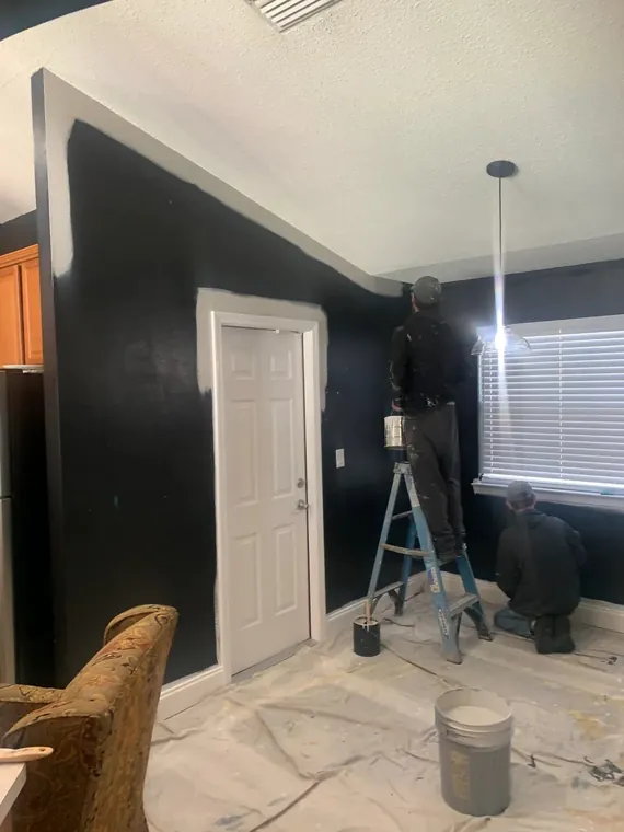 Interior accent wall painted in deep black with crisp white trim