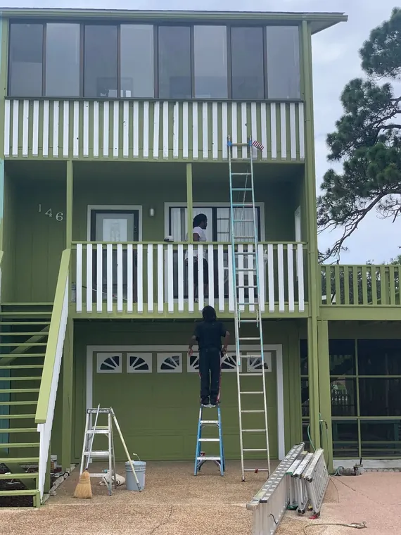 Exterior repaint of a green three-story coastal home