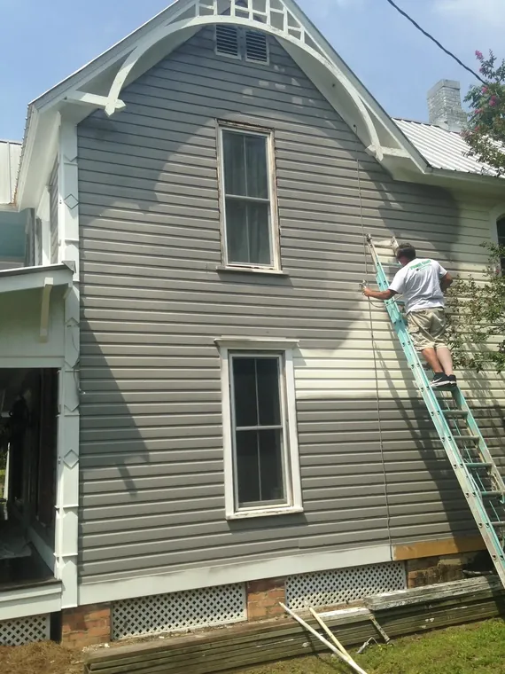 Spray-applied exterior repaint of a historic gabled home