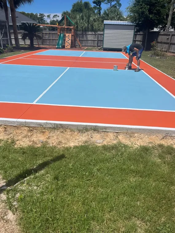 Custom backyard sport court painting in blue and orange